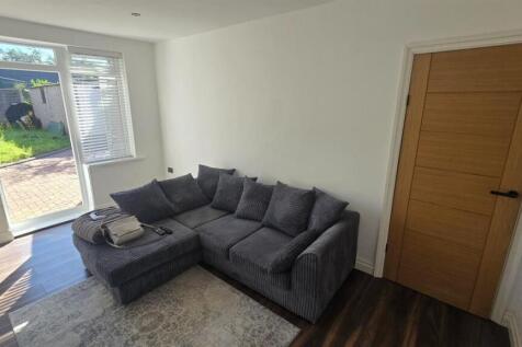A spacious and welcoming living room filled wit...