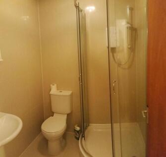 A clean and functional bathroom suite featuring...