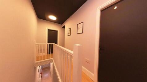 A well-maintained hallway illuminated by soft l...