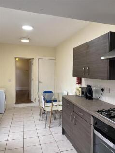 A well-maintained kitchen area with modern cabi...