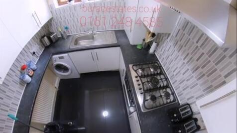 Photo of a compact kitchen area featuring a cou...