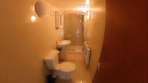 A spacious bathroom suite featuring a large bat...