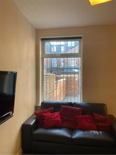 A cozy living room featuring a comfortable blac...