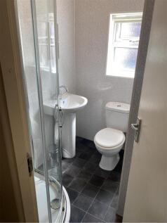 A compact, well-maintained bathroom featuring a...