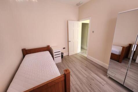 A bright and clean student bedroom featuring a ...