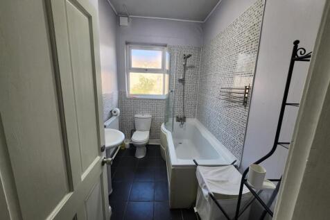 A bright, well-maintained bathroom featuring a ...
