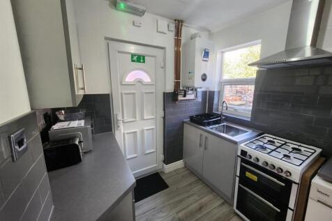A modern, well-lit kitchen with clean surfaces,...