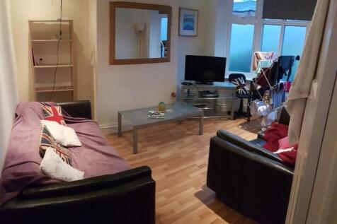 A spacious and well-lit living room featuring c...