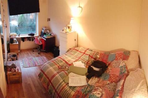 A cozy and welcoming living room featuring a pa...