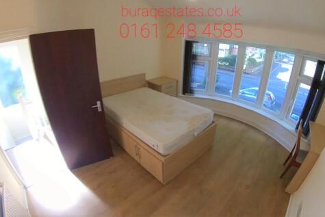 A bright and inviting double bedroom with a lar...