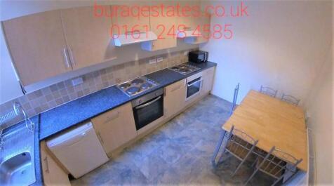 A modern kitchen featuring ample countertop spa...