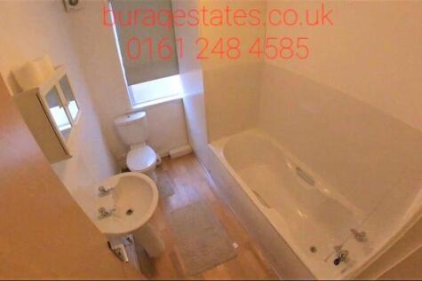 A clean and functional bathroom featuring a ful...