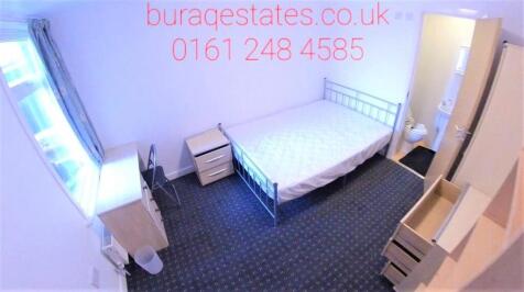 A neat and tidy single bedroom featuring a meta...