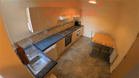 A compact, well-organized kitchen featuring a l...