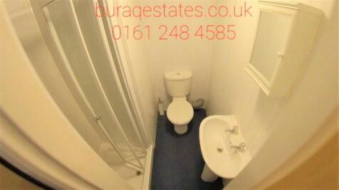 Compact and clean single toilet featuring a whi...