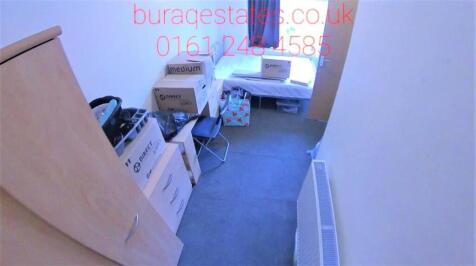 A neat and functional single bedroom featuring ...