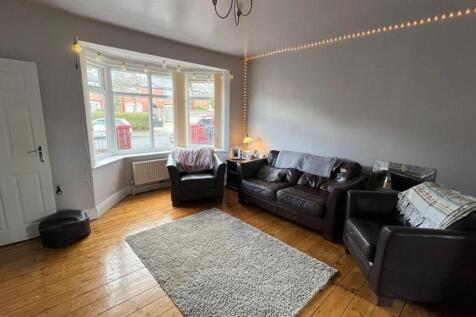 A spacious and inviting living room featuring a...