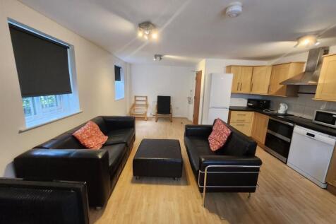 Spacious and modern living room featuring comfo...