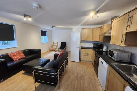 Bright open-plan living area with comfortable s...