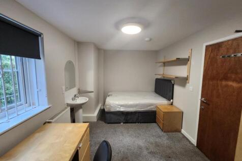 A neatly maintained single bedroom featuring a ...