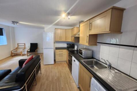 A bright and modern kitchen featuring ample cab...