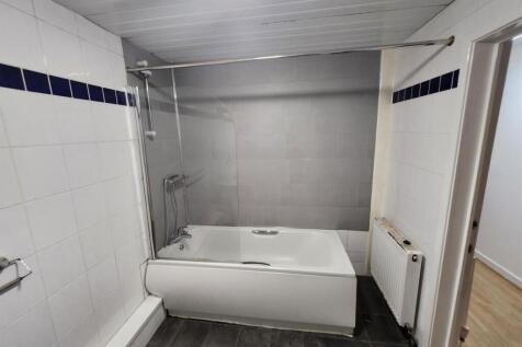 A clean and spacious bathroom featuring a large...