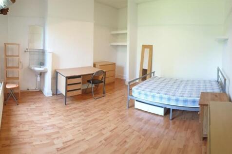 A bright and clean single bedroom featuring a c...