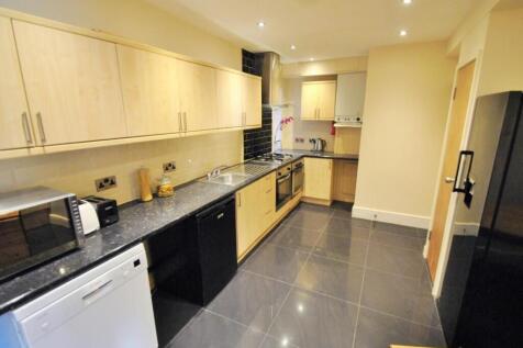 Bright and modern kitchen featuring sleek black...