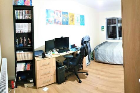 A well-organized bedroom featuring a comfortabl...