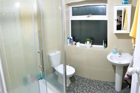 A clean, well-lit bathroom featuring a spacious...