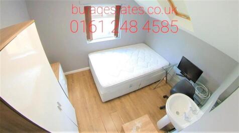 A well-maintained bedroom with a single bed, wa...