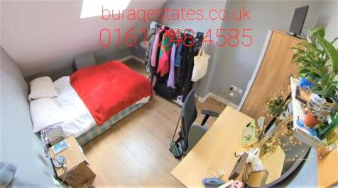 A bright and cozy single bedroom with a bed, wa...