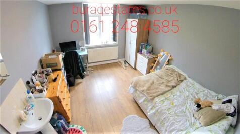 A cozy bedroom featuring a single bed with a so...