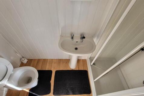 Bright and neat bathroom featuring a clean whit...