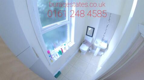 A bright and clean bathroom suite featuring a l...