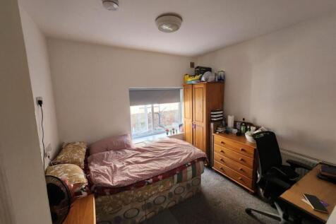 A cozy bedroom with natural light coming throug...