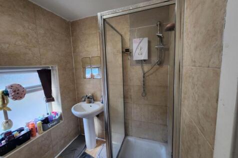 A well-maintained bathroom featuring a shower w...