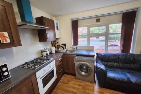 A well-lit, modern kitchen with ample counterto...