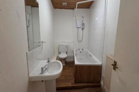 A clean, well-maintained bathroom with a bathtu...