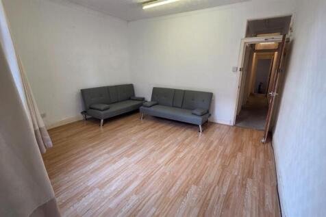 A spacious and well-lit contemporary living roo...