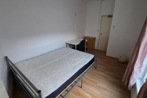 A cozy and tidy single bedroom with a simple be...