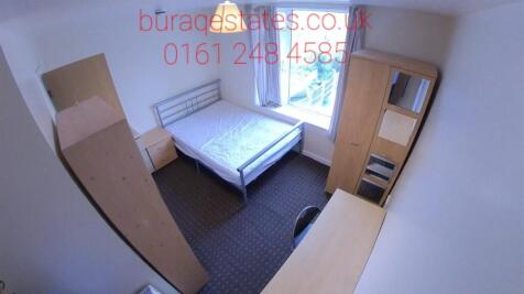 Bright single bedroom with a simple metal bed f...