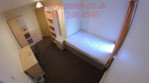 A neat and well-organized single bedroom featur...