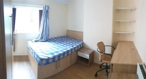 A modest single bedroom with a window bringing ...