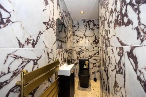 A modern and stylish bathroom featuring strikin...