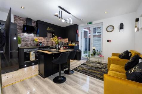 Stylish open-plan living area with a modern bla...