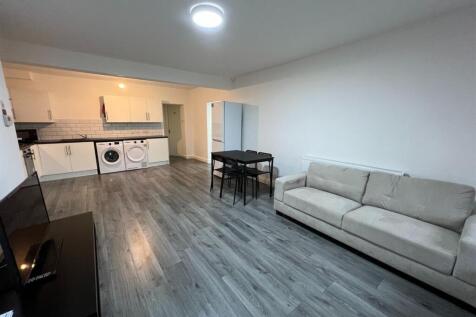 A spacious, modern living room featuring a comf...