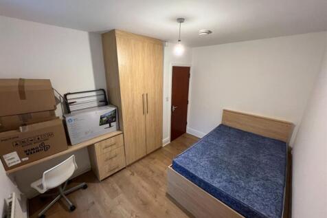 A cozy bedroom featuring a double bed with a bl...