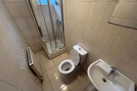 A clean and modern bathroom featuring a toilet,...