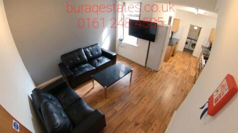 Bright, modern living area with wood-effect flo...